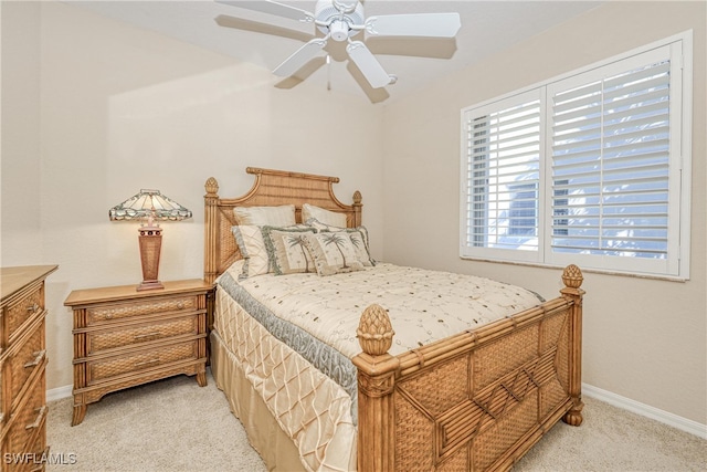 bedroom featuring baseboards, light carpet, and ceiling fan