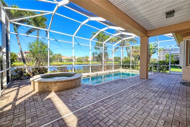 view of pool featuring a lanai, a water view, a pool with connected hot tub, and a patio