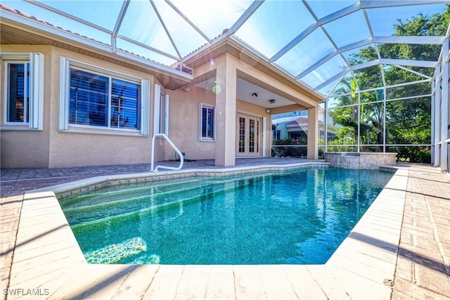 pool with french doors, a lanai, and a patio area