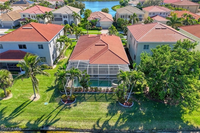 drone / aerial view with a residential view and a water view