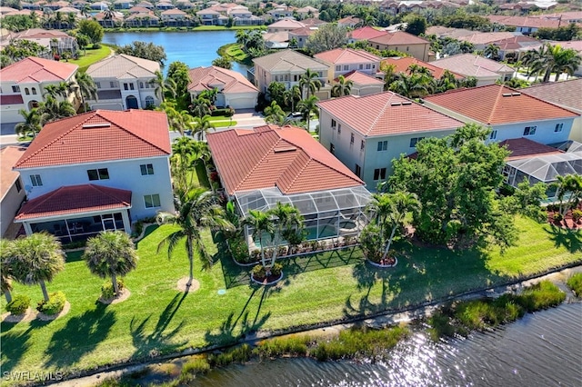 drone / aerial view with a residential view and a water view