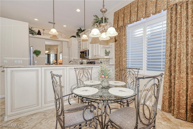 dining space featuring a notable chandelier, recessed lighting, and visible vents