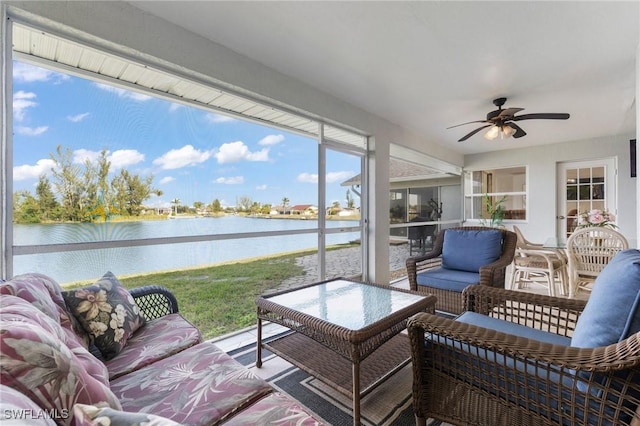 sunroom / solarium with a ceiling fan, a water view, and plenty of natural light