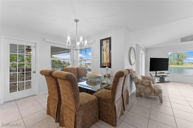 dining area featuring lofted ceiling, baseboards, an inviting chandelier, and light tile patterned floors