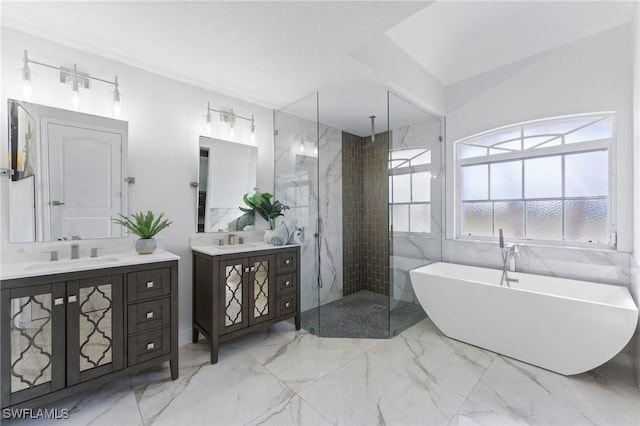 full bathroom with a walk in shower, two vanities, a sink, a freestanding bath, and marble finish floor