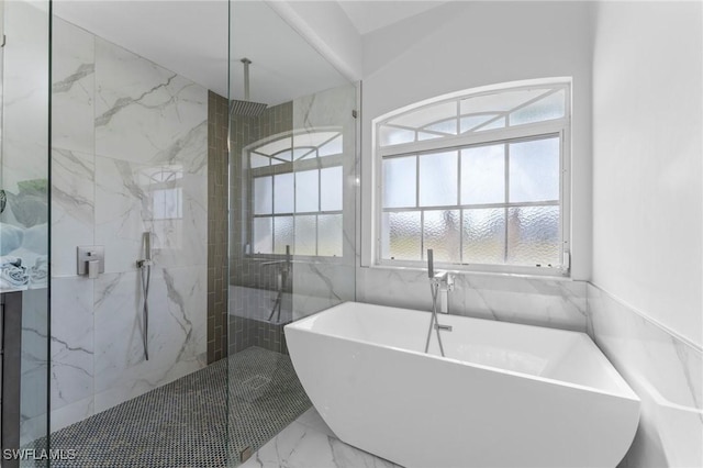 full bath with marble finish floor, a freestanding tub, and a marble finish shower