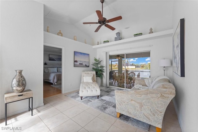 living area featuring tile patterned flooring, vaulted ceiling, and a ceiling fan