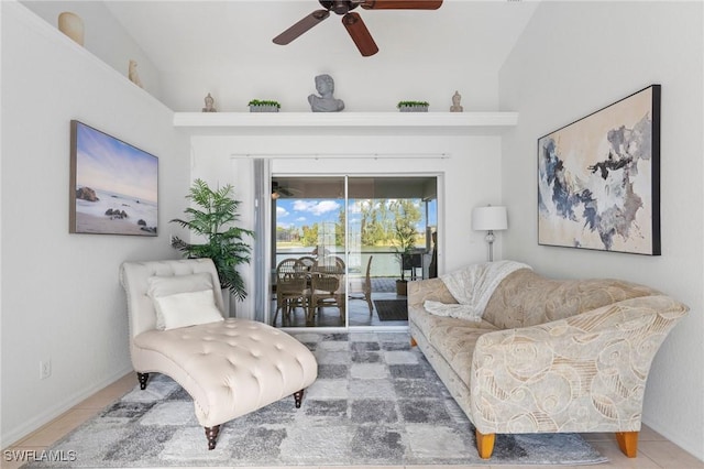 living area with ceiling fan, tile patterned flooring, and baseboards