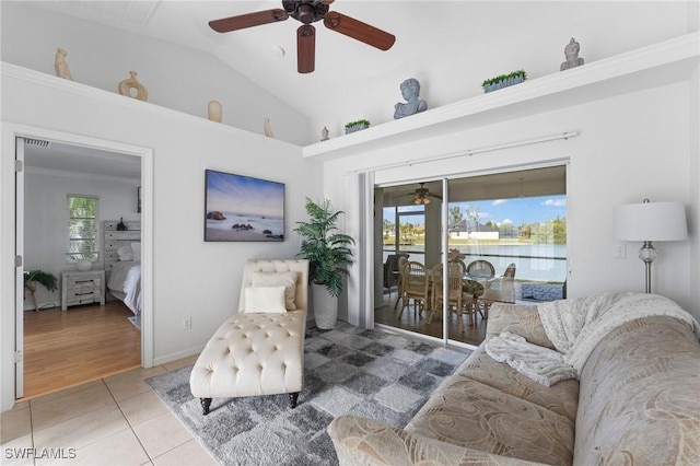 sitting room with lofted ceiling, a healthy amount of sunlight, ceiling fan, and tile patterned floors