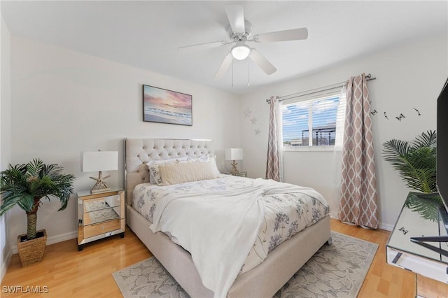 bedroom featuring light wood-style floors, ceiling fan, and baseboards