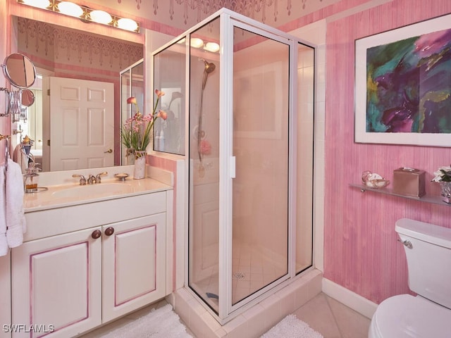 bathroom featuring wallpapered walls, vanity, toilet, and a stall shower
