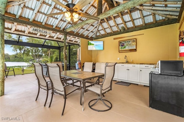 interior space with outdoor dining space, a water view, and a sink