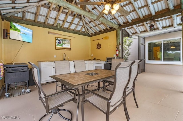 view of patio / terrace with exterior kitchen, outdoor dining area, ceiling fan, and a sink