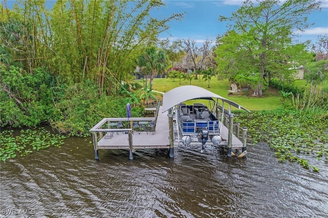 dock area with a yard, a water view, and boat lift