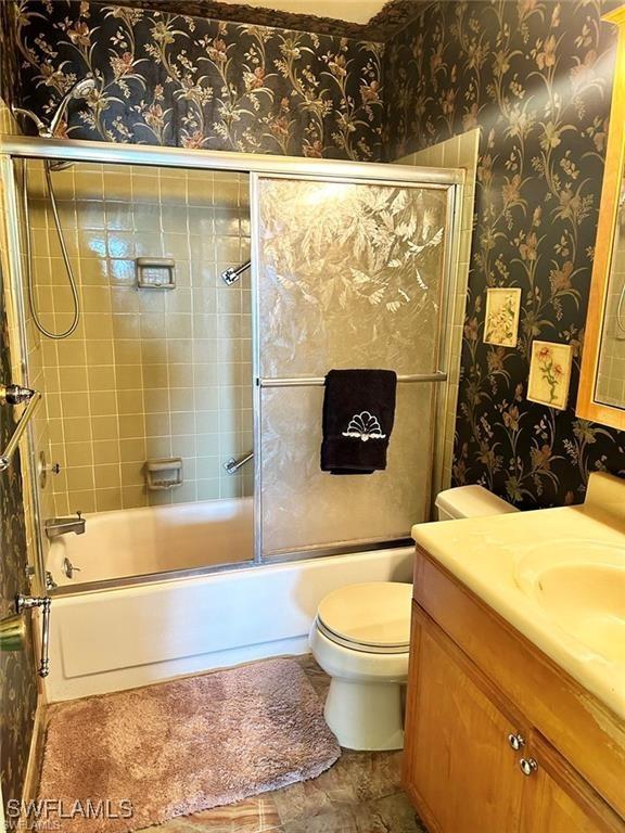 5910 Via Delray Blvd Unit B, Delray Beach, FL 33484 - full bath with wallpapered walls, toilet, enclosed tub / shower combo, and vanity