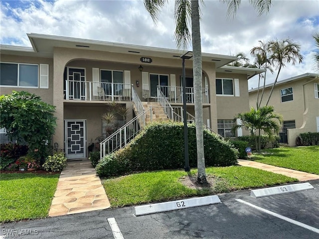 5910 Via Delray Blvd Unit B, Delray Beach, FL 33484 - view of property with stairway and uncovered parking