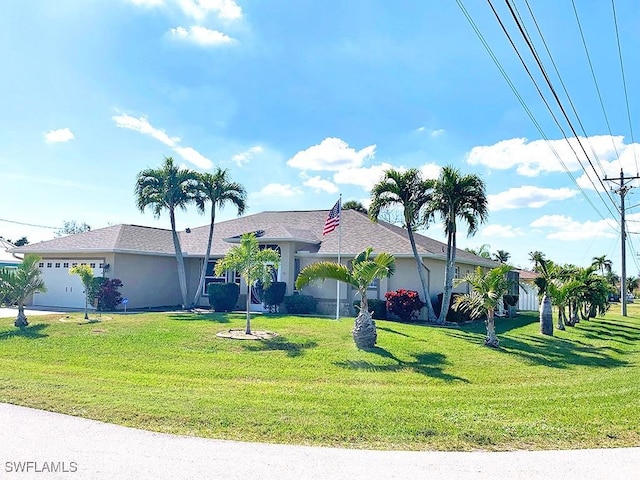 ranch-style home with a front yard, an attached garage, and stucco siding