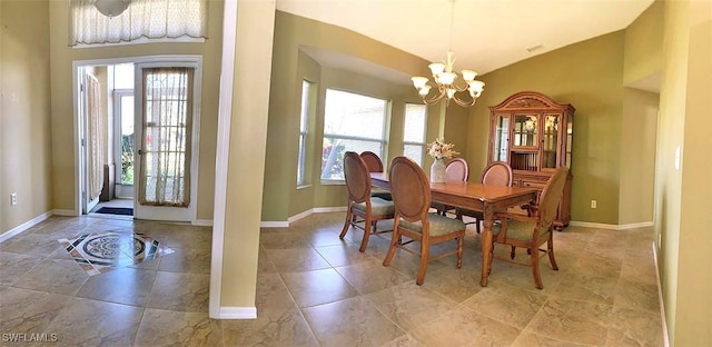 dining space with a chandelier, high vaulted ceiling, plenty of natural light, and baseboards