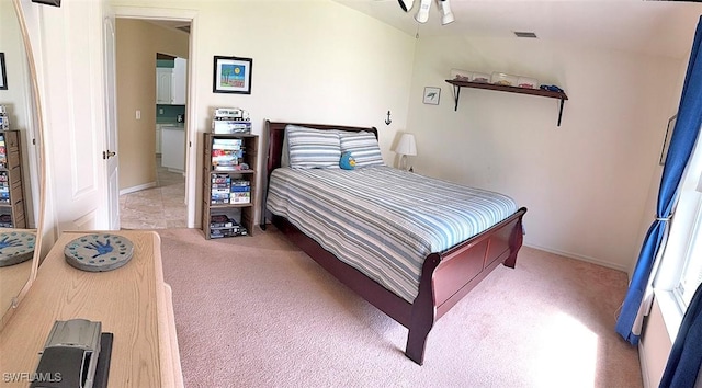 carpeted bedroom featuring visible vents