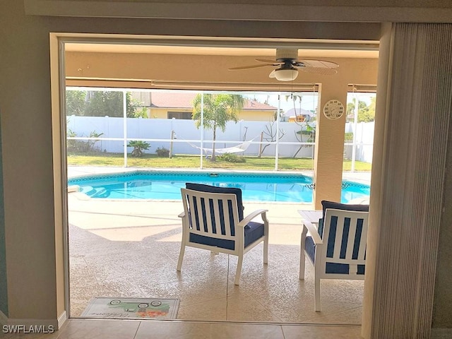 view of pool with a fenced in pool, a patio area, glass enclosure, fence, and ceiling fan