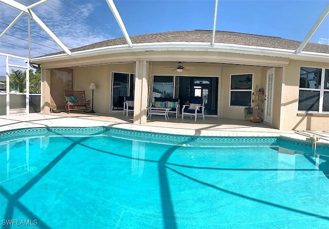 pool featuring a lanai, a ceiling fan, and a patio