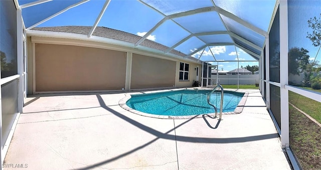 view of pool with a patio area, fence, a fenced in pool, and a lanai