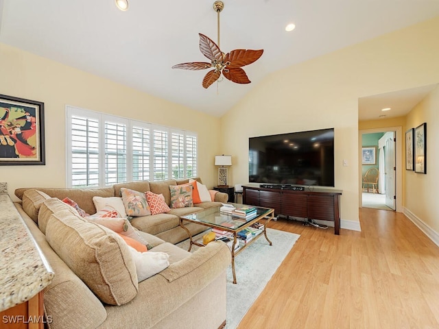 living area featuring baseboards, lofted ceiling, ceiling fan, light wood-type flooring, and recessed lighting