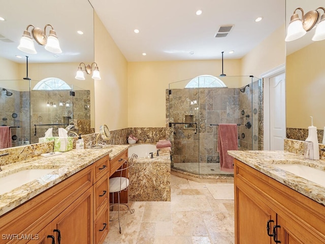 bathroom featuring plenty of natural light, a shower stall, and a sink