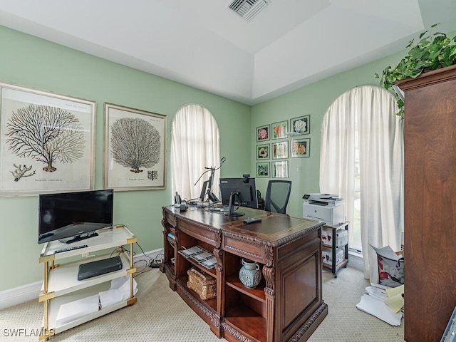 office area featuring carpet floors, baseboards, visible vents, and a raised ceiling