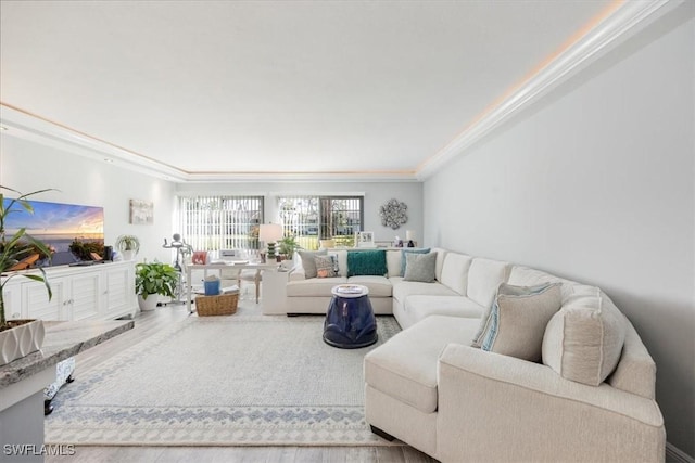 living room featuring ornamental molding and wood finished floors