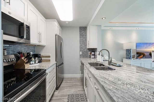 1085 Forest Lakes Dr Unit 8105, Naples, FL 34105 - kitchen with light stone counters, stainless steel appliances, tasteful backsplash, white cabinets, and a sink