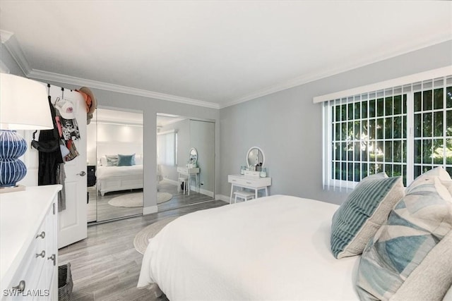 1085 Forest Lakes Dr Unit 8105, Naples, FL 34105 - bedroom with crown molding, light wood finished floors, baseboards, and multiple closets