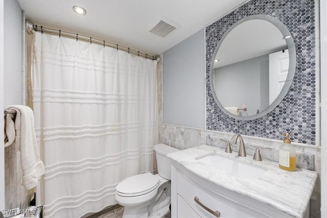 1085 Forest Lakes Dr Unit 8105, Naples, FL 34105 - full bathroom with visible vents, wainscoting, toilet, vanity, and tile walls