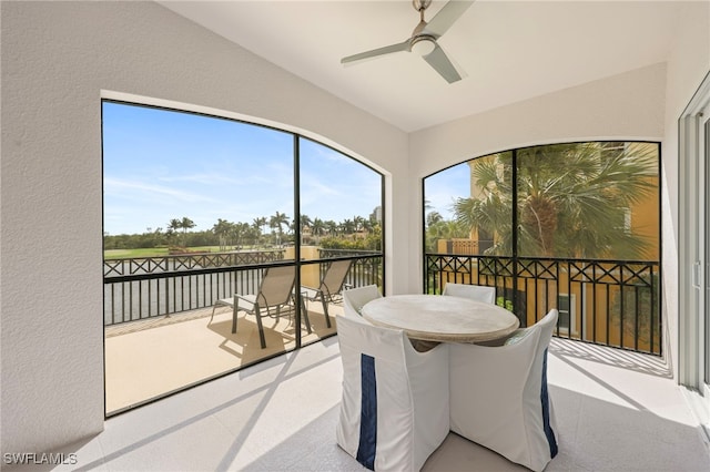 sunroom / solarium featuring a ceiling fan