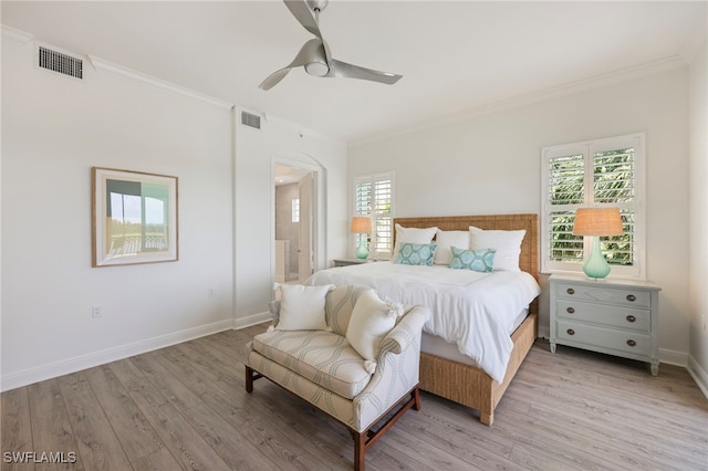 bedroom featuring light wood-type flooring, visible vents, and crown molding