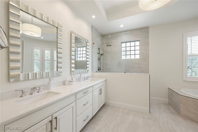 bathroom with double vanity, a sink, a bath, and walk in shower