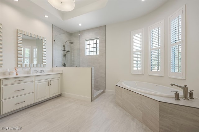 bathroom with a garden tub, recessed lighting, vanity, baseboards, and walk in shower