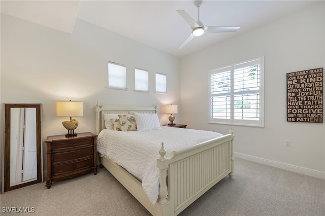 bedroom with baseboards, a ceiling fan, and light colored carpet