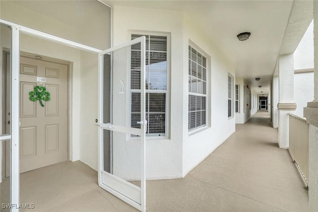 entrance to property featuring stucco siding