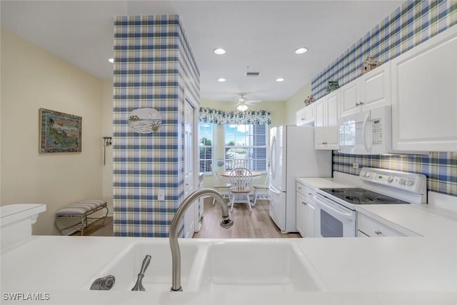 kitchen featuring light countertops, white appliances, white cabinetry, and decorative backsplash