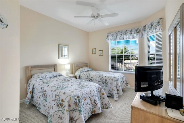 bedroom featuring baseboards, a ceiling fan, and carpet flooring