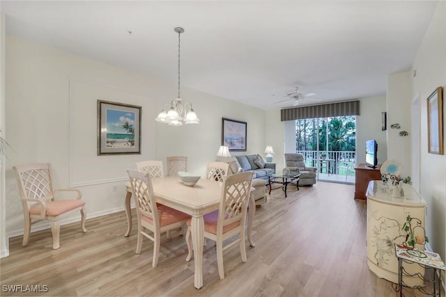 dining room with baseboards, light wood finished floors, and ceiling fan with notable chandelier