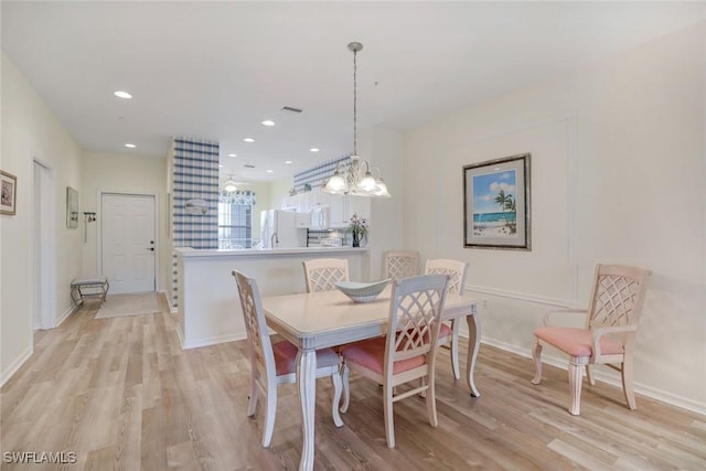 dining room featuring light wood-type flooring, baseboards, visible vents, and recessed lighting