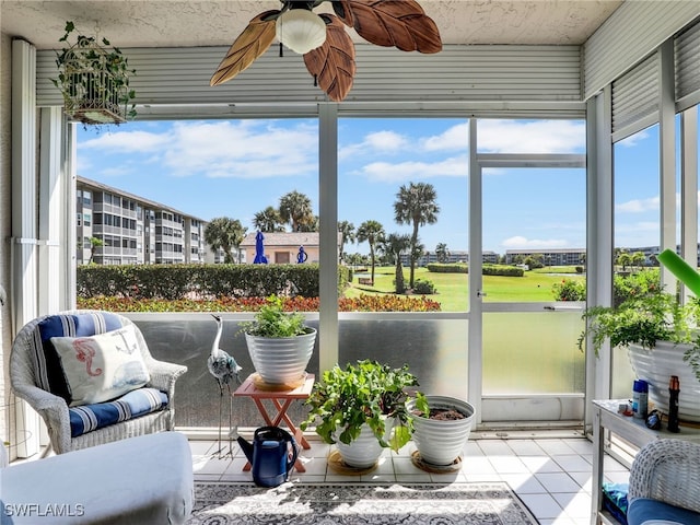 sunroom featuring ceiling fan