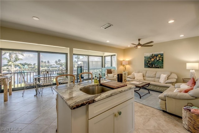 kitchen featuring visible vents, open floor plan, a sink, and recessed lighting