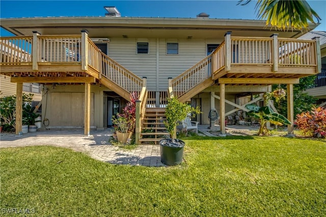 back of property with a deck, a yard, a patio, and stairs