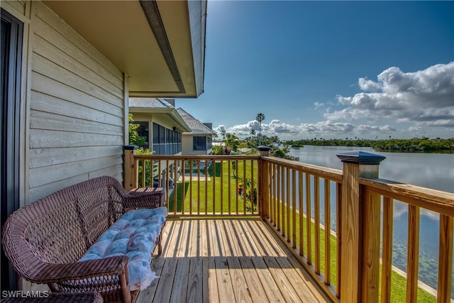 wooden terrace featuring a water view