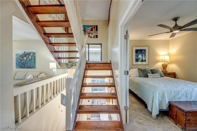 stairs with a ceiling fan