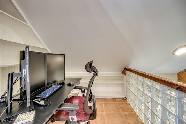 workout room featuring light tile patterned floors and lofted ceiling