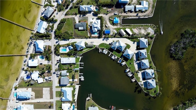 drone / aerial view featuring a residential view and a water view